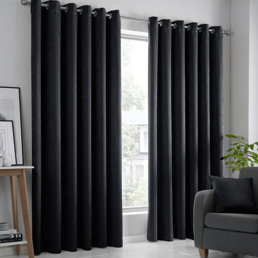 Fusion Strata dim-out eyelet curtains in black.