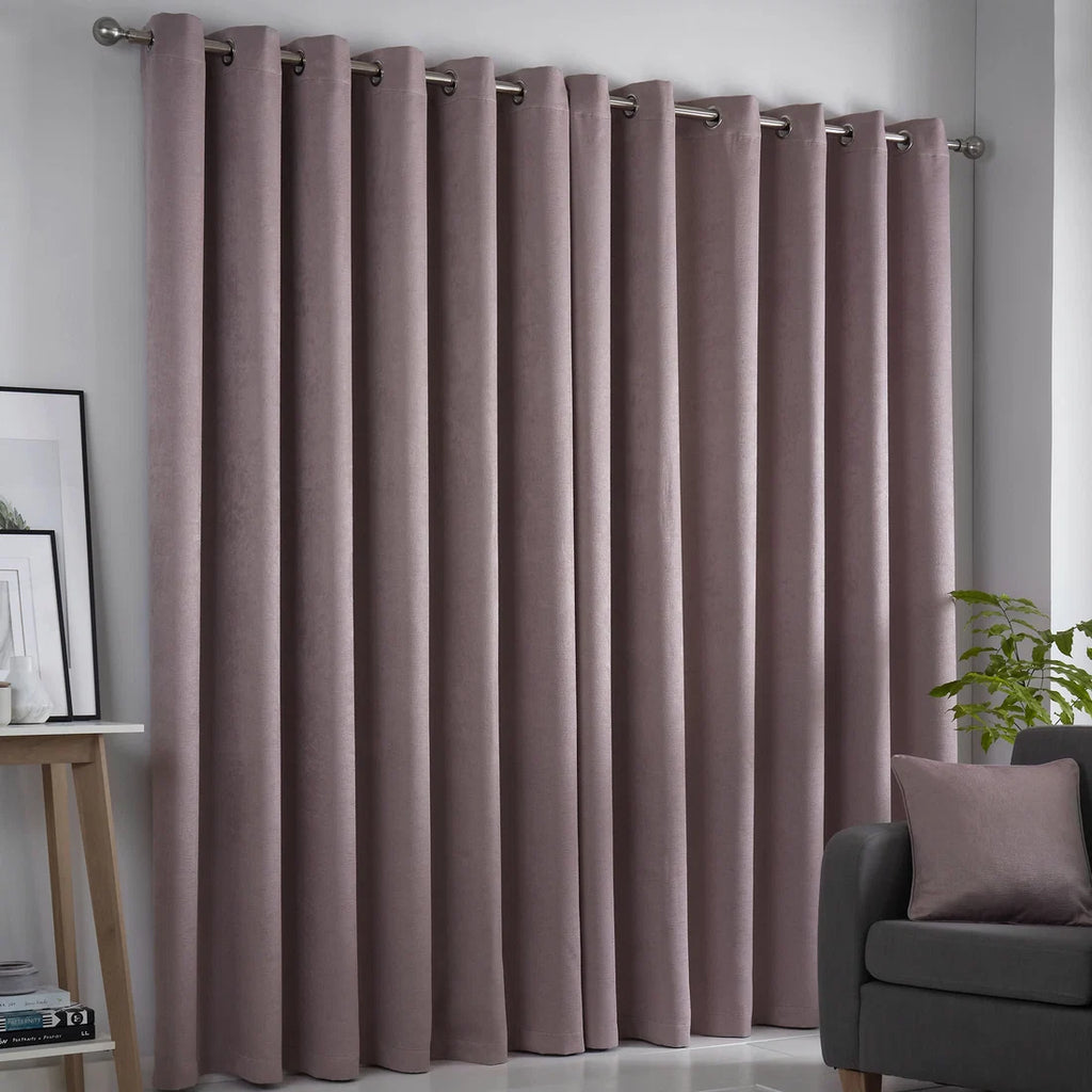 Fusion Strata blush eyelet curtains styled in a contemporary living room.