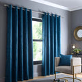 Fusion Strata dim-out eyelet curtains in dark teal.