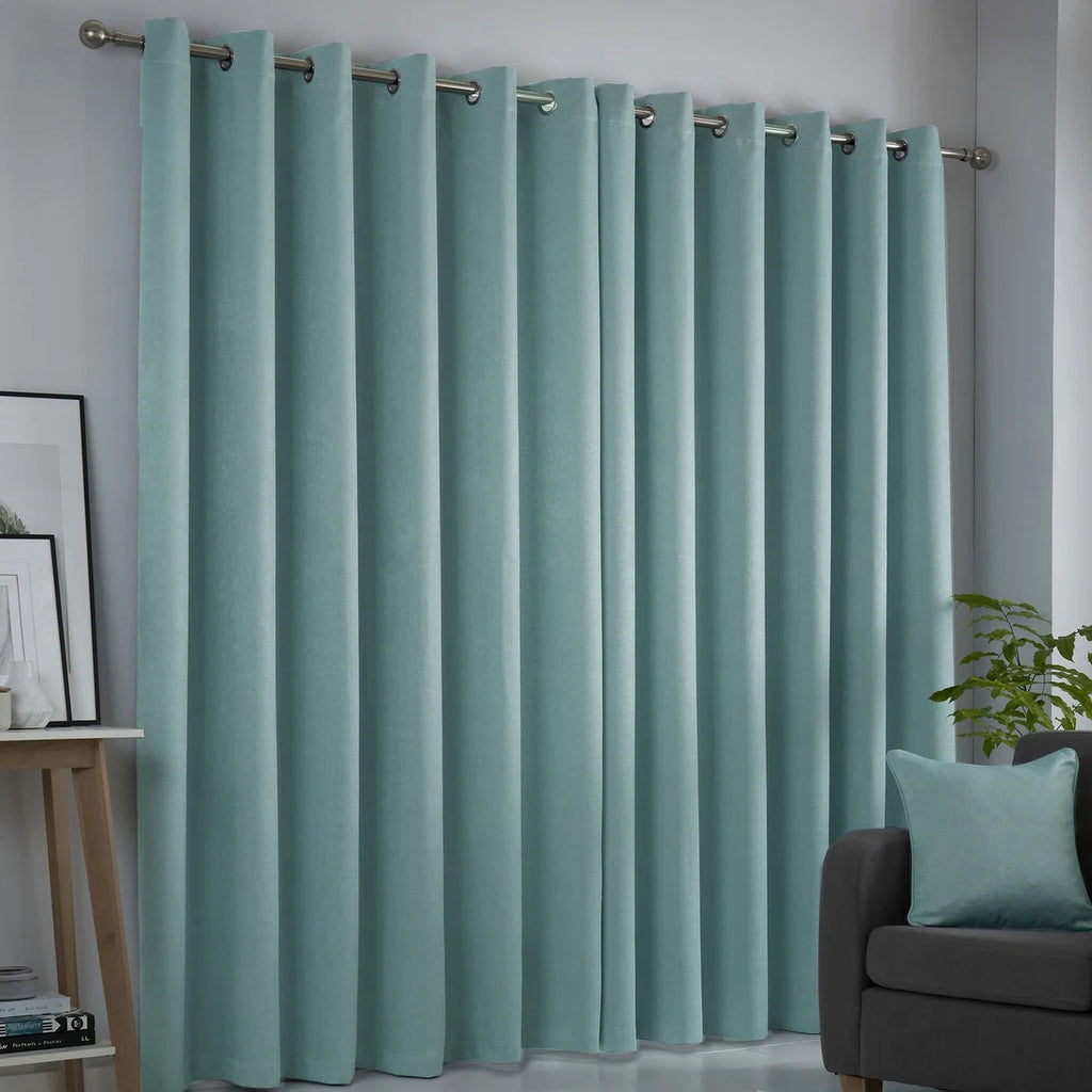 Fusion Strata duck egg eyelet curtains styled in a contemporary living room.