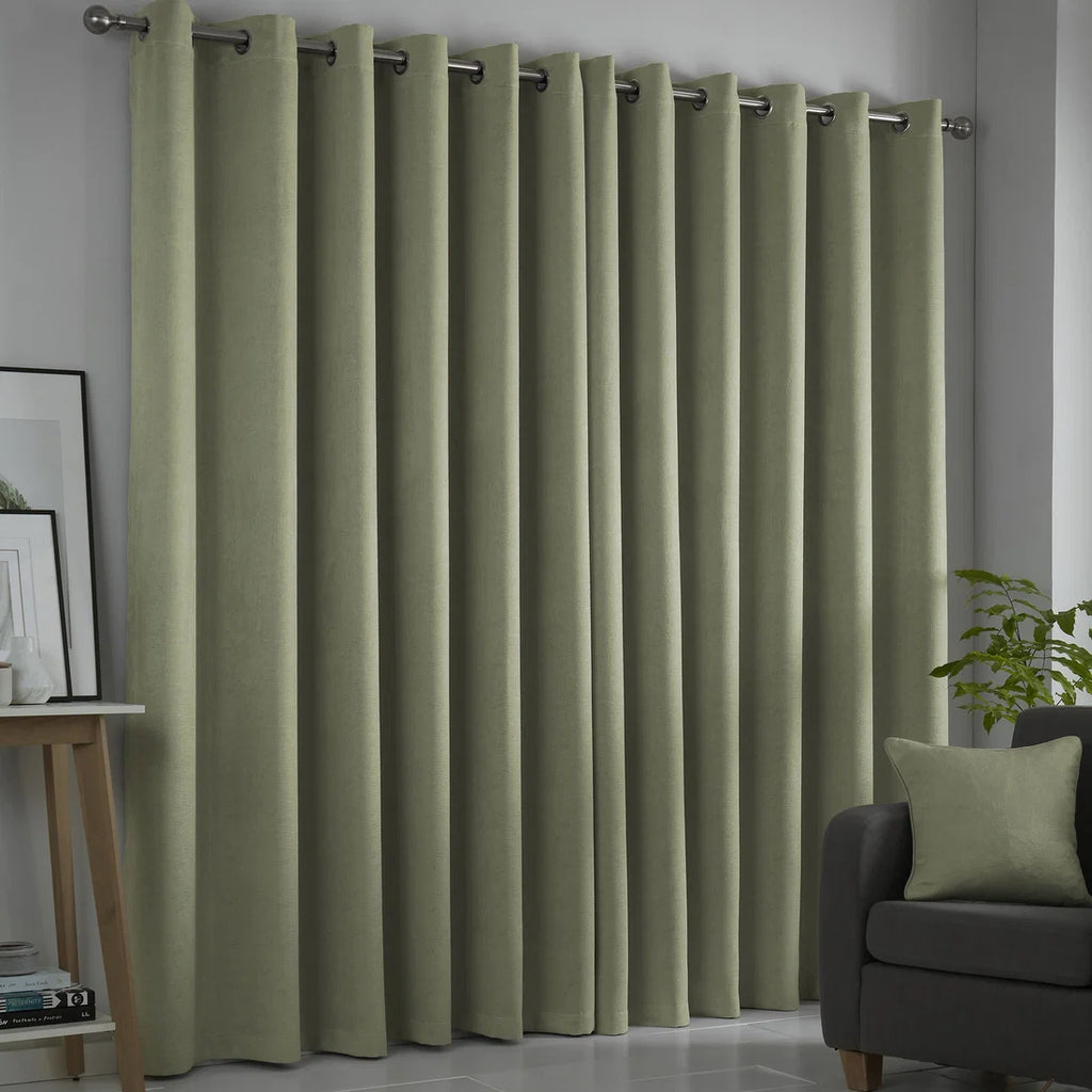 Fusion Strata green eyelet curtains styled in a contemporary living room.