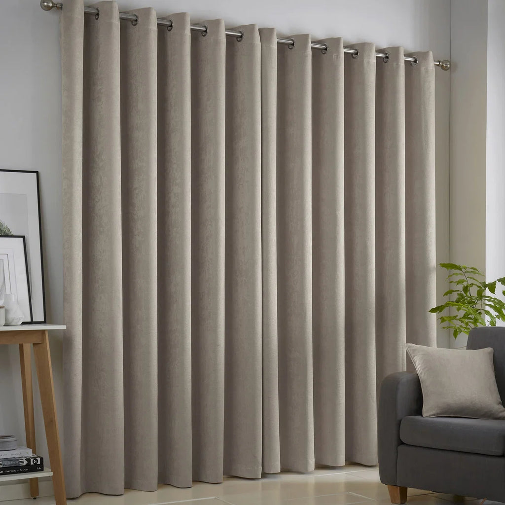 Fusion Strata natural eyelet curtains styled in a contemporary living room.