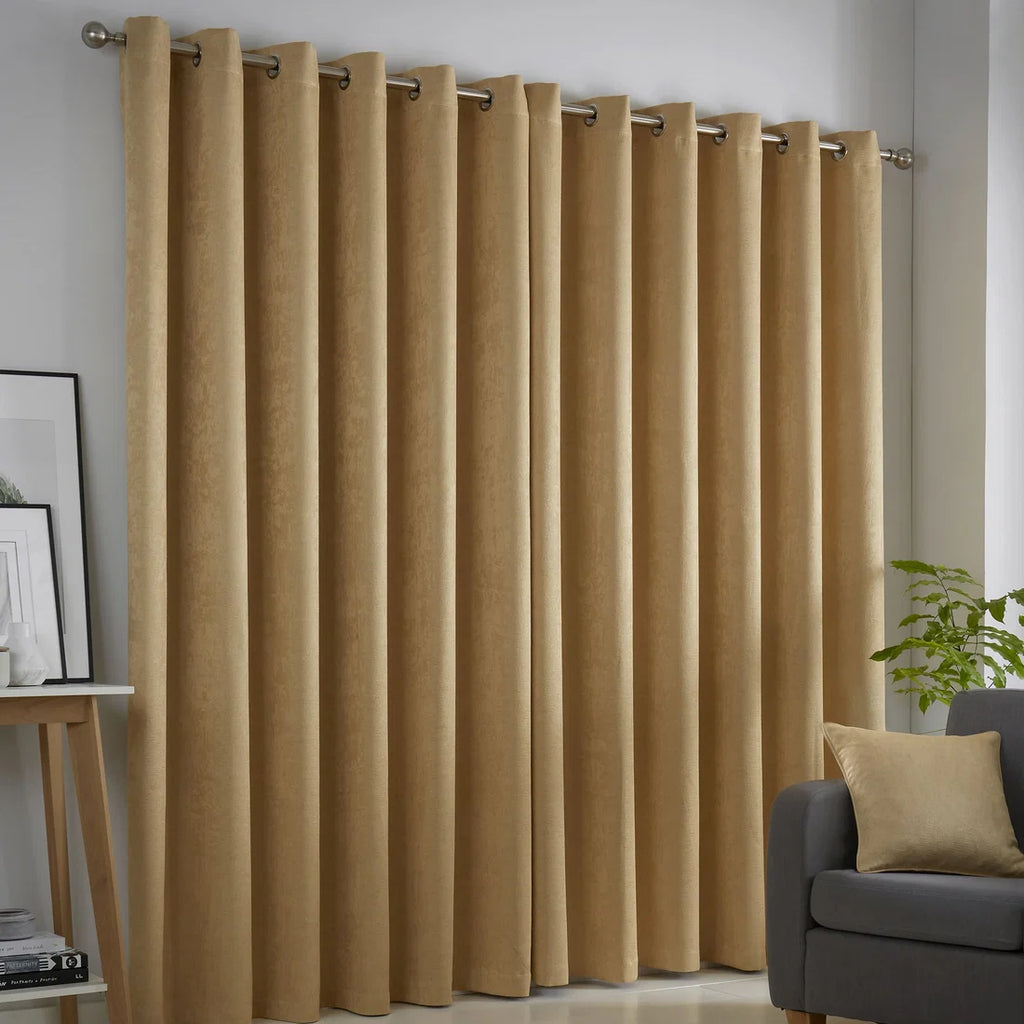 Fusion Strata ochre eyelet curtains styled in a contemporary living room.