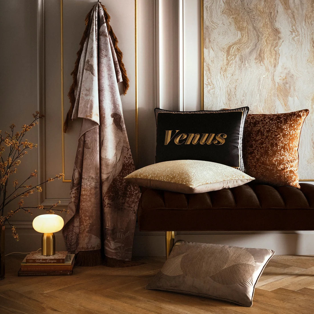 Laurence Llewelyn-Bowen Atlas Spice cushion styled in a luxurious interior.