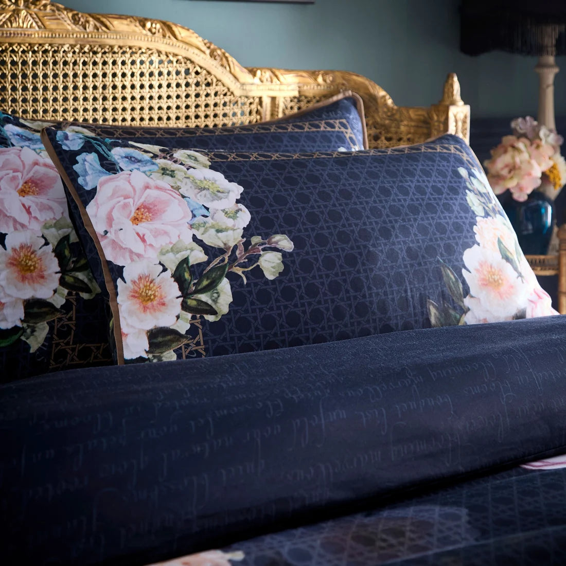 Close-up of the vibrant floral, trellis and script design on the Laurence Llewelyn-Bowen Bouquet List duvet cover set.
