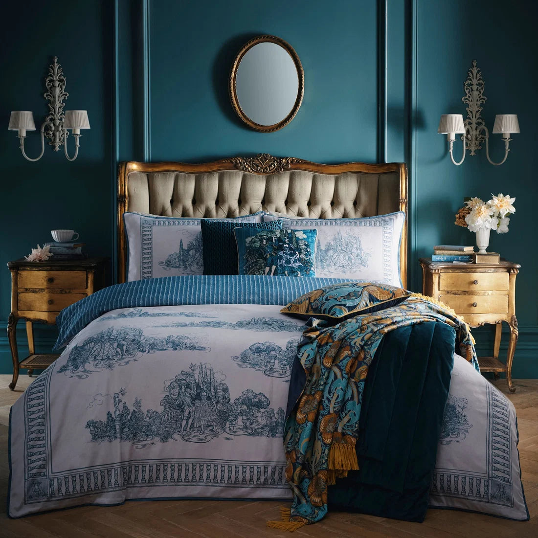 Laurence Llewelyn-Bowen Tuscan Toile blue velvet cushion styled on the matching bedding