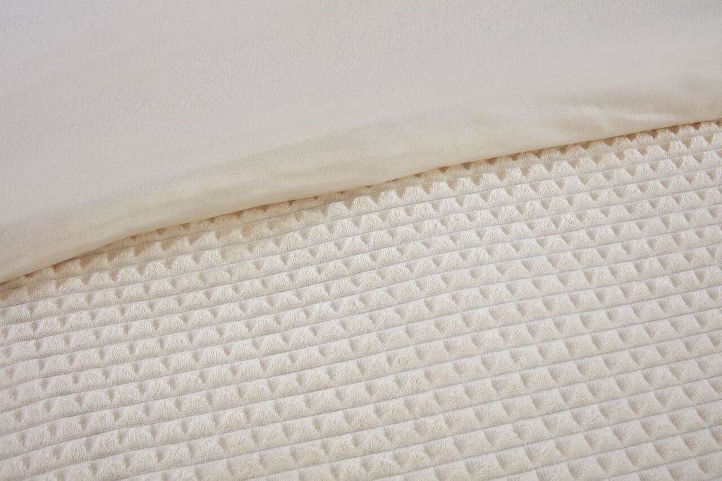 Close-up of the waffle textured teddy fleece on the Luxury Waffle duvet cover set in Natural.