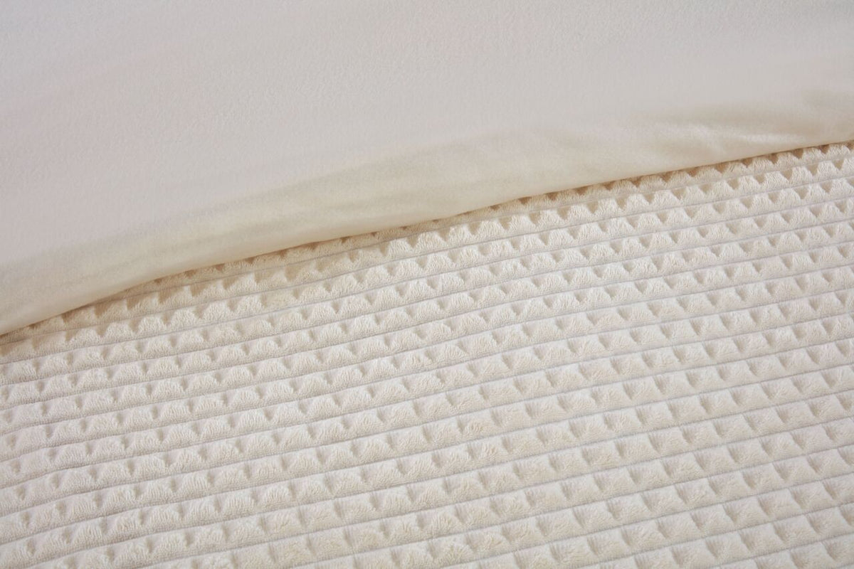 Close-up of the waffle textured teddy fleece on the Luxury Waffle duvet cover set in Natural.