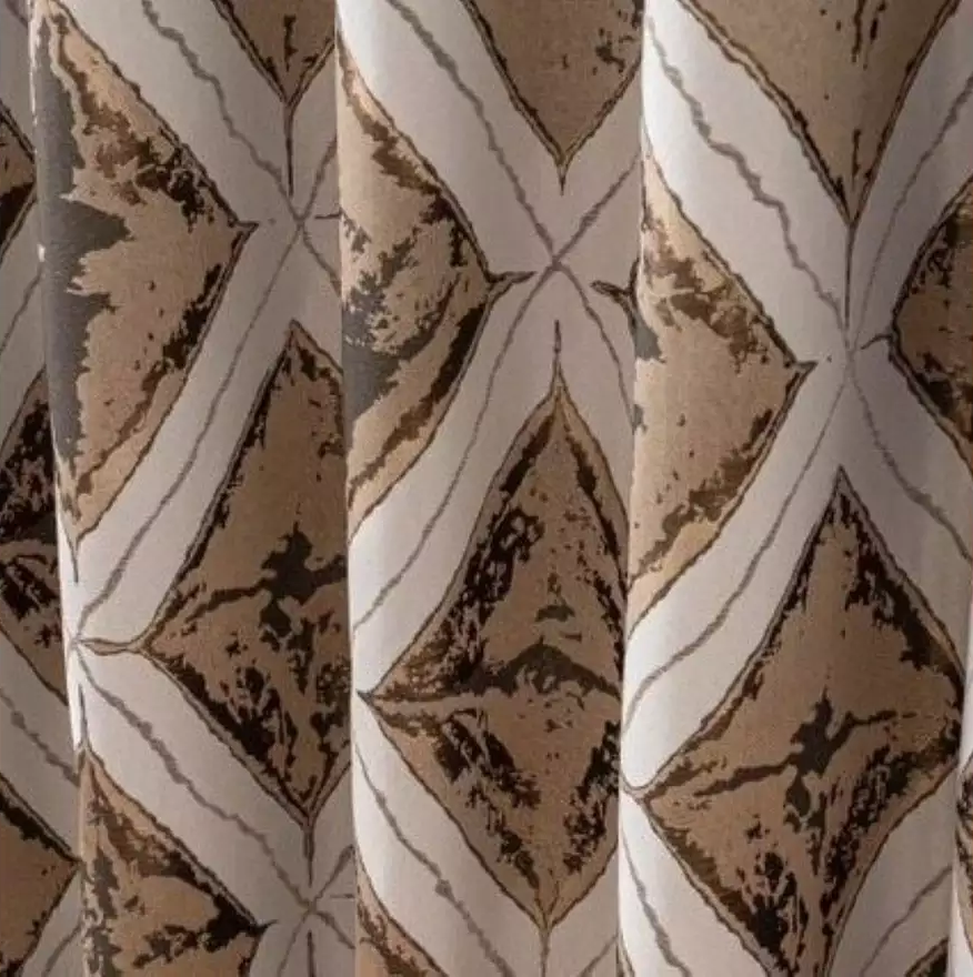 Close-up of the metallic diamond jacquard pattern on the Matrix Cream and Gold curtains.