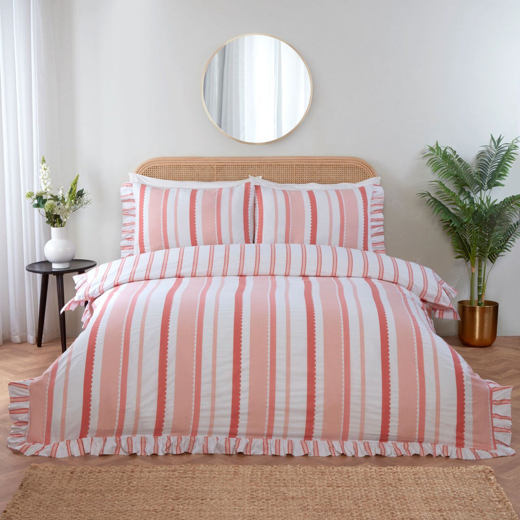 Maya Frilled pink duvet cover set styled in a bright and elegant bedroom.