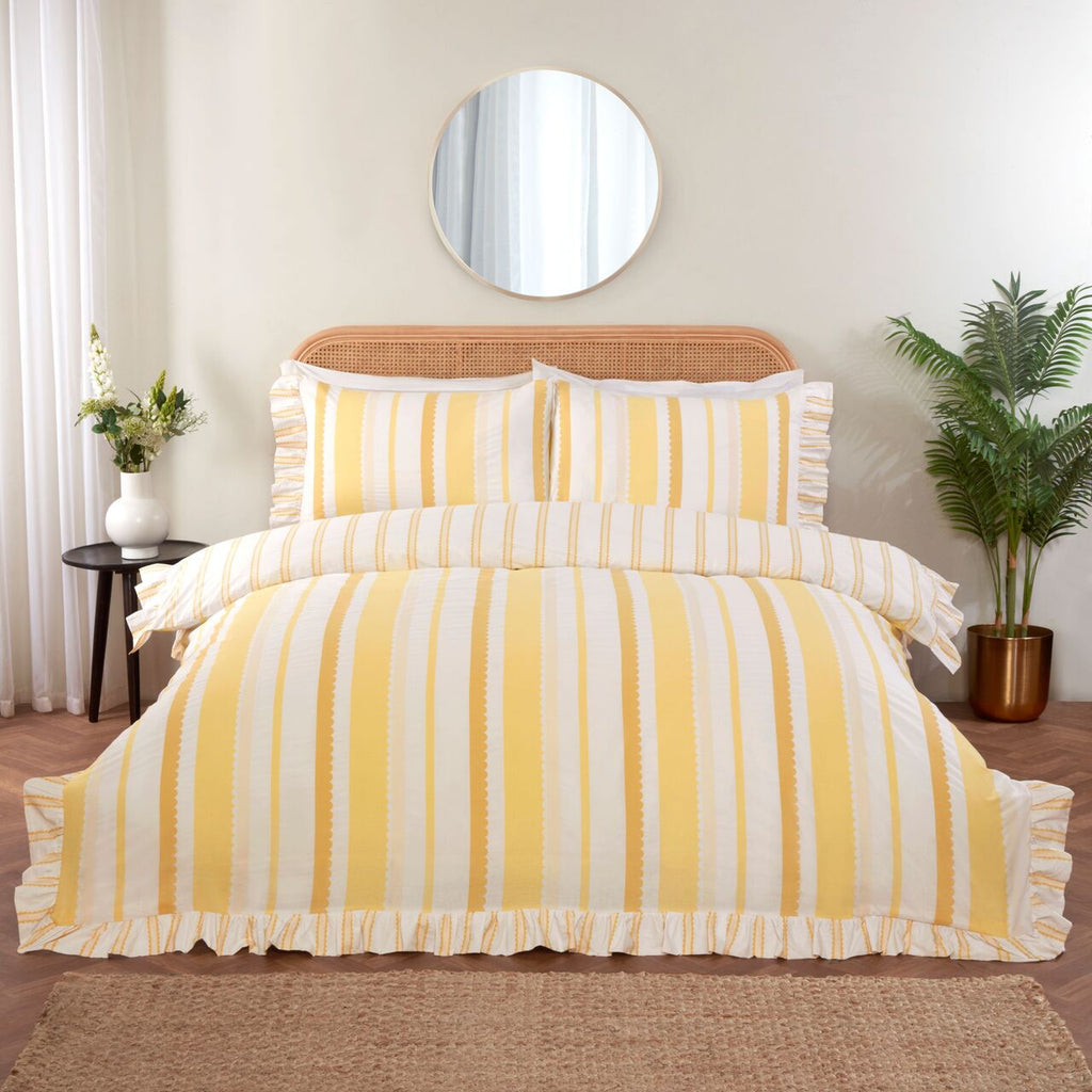 Maya Frilled yellow duvet cover set styled in a bright and elegant bedroom.