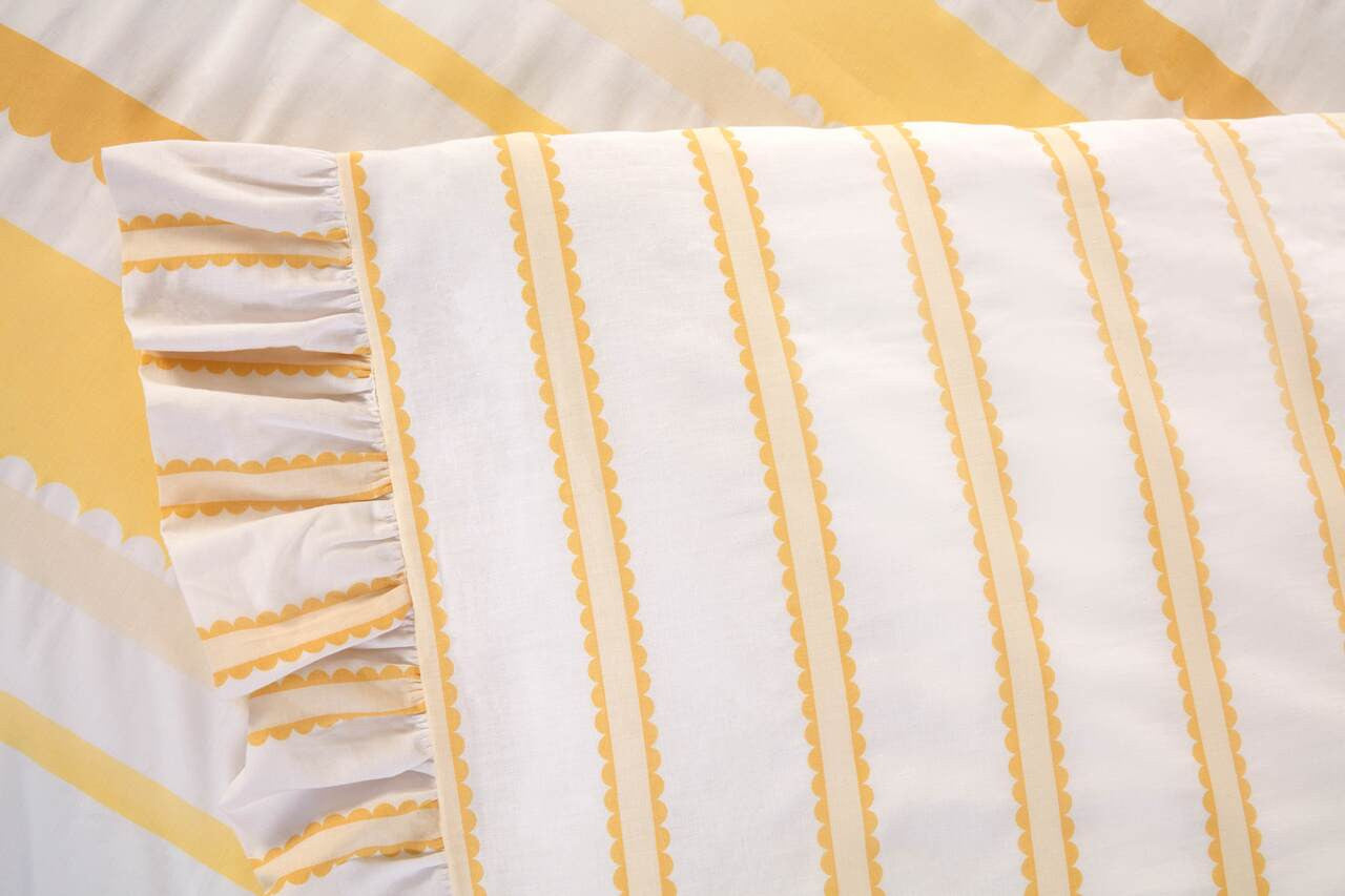 Close-up of the oversized frilled border on the Maya Frilled yellow duvet cover set.