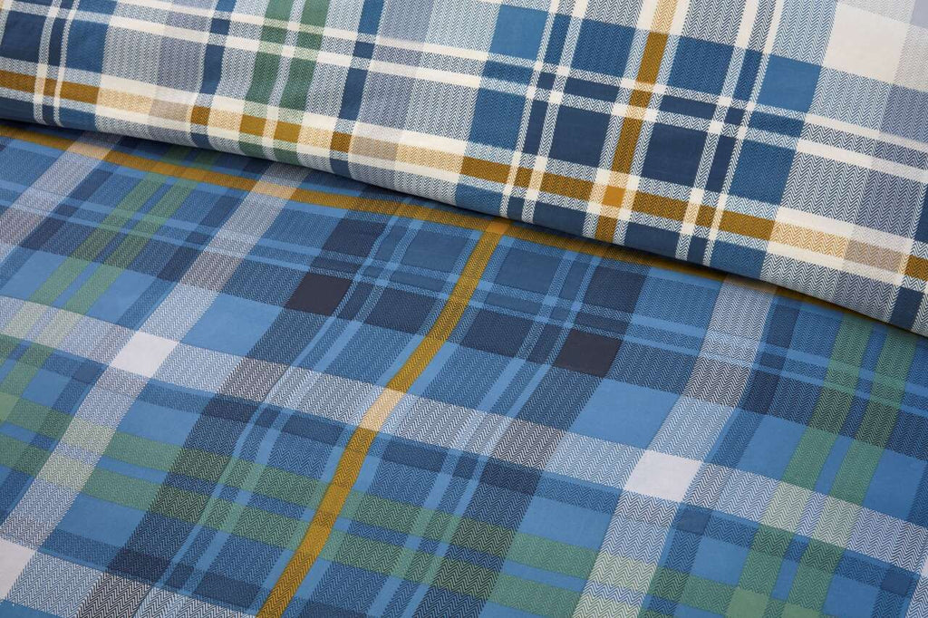 Close-up of the soft microfibre fabric on the Regalia Complete blue check duvet cover set.