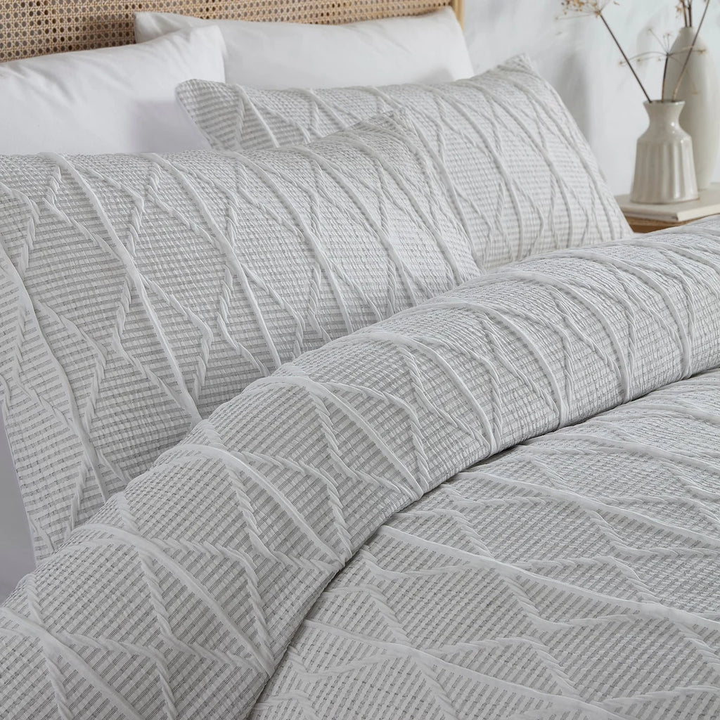 Close-up of the textured geometric crinkle stripe design on the Serene duvet cover set.