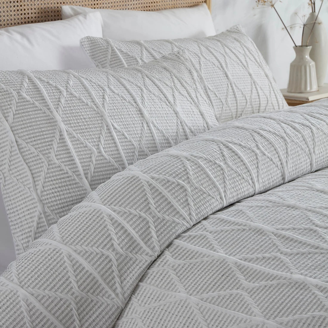 Close-up of the textured geometric crinkle stripe design on the Serene duvet cover set.