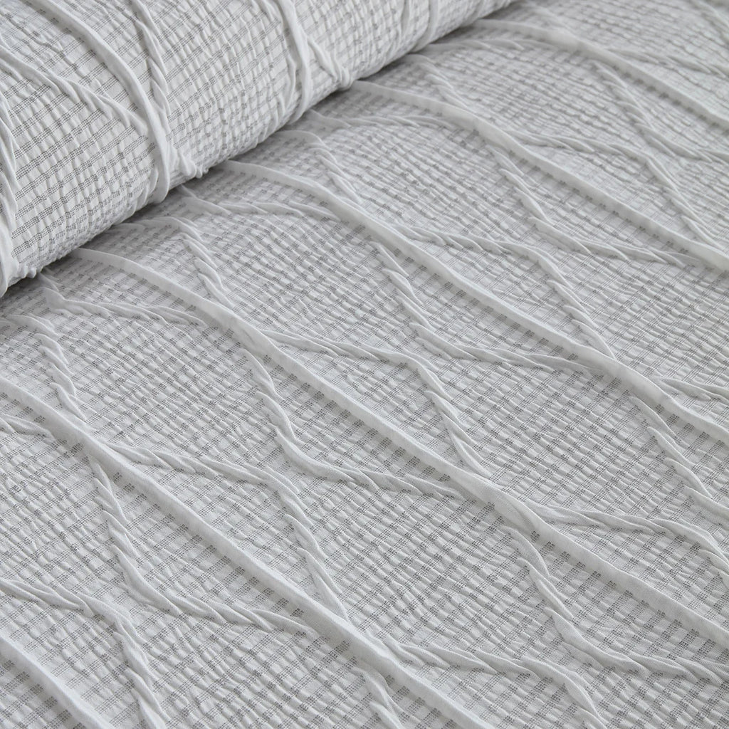 Close-up of the soft polyester fabric on the Serene Crinkle Stripe duvet cover set.