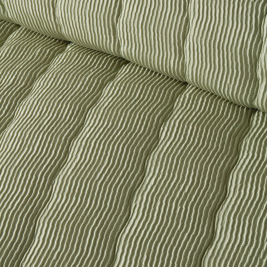 Close-up of the soft polyester fabric on the Serene Crinkle Wave duvet cover set.