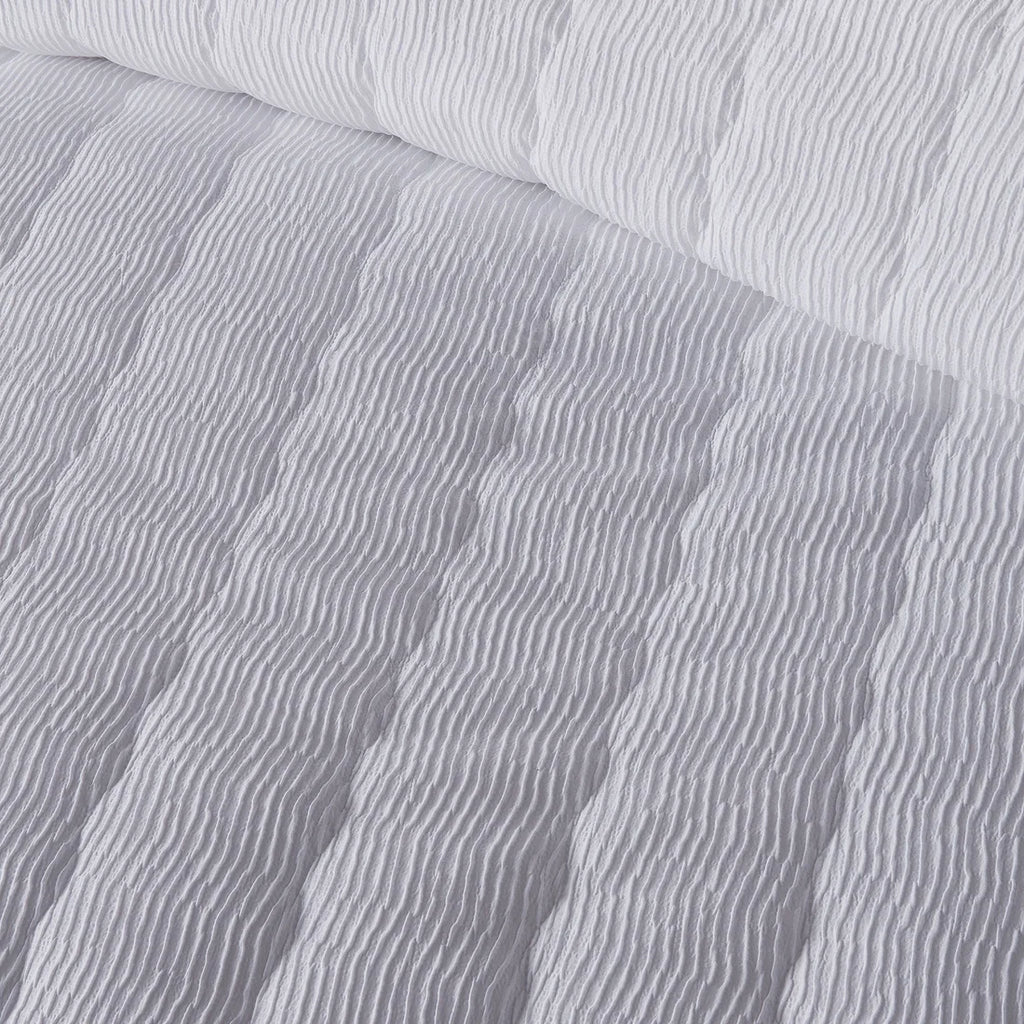 Close-up of the soft polyester fabric on the Serene Crinkle Wave duvet cover set.