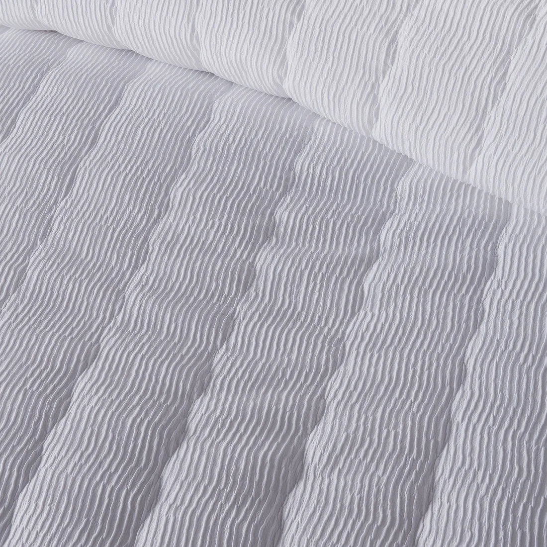 Close-up of the soft polyester fabric on the Serene Crinkle Wave duvet cover set.