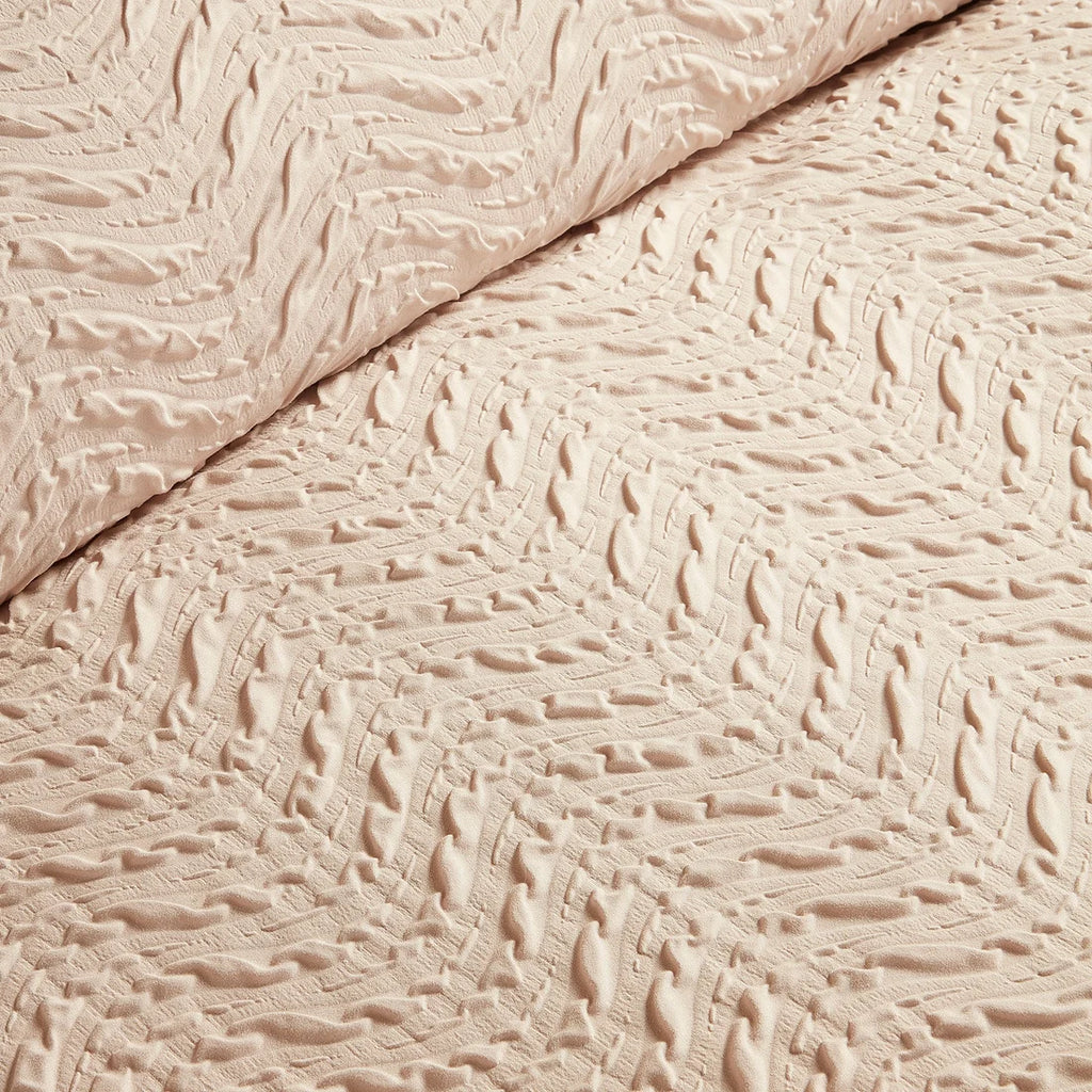 Close-up of the soft polyester fabric on the Serene Embossed Curve duvet cover set.