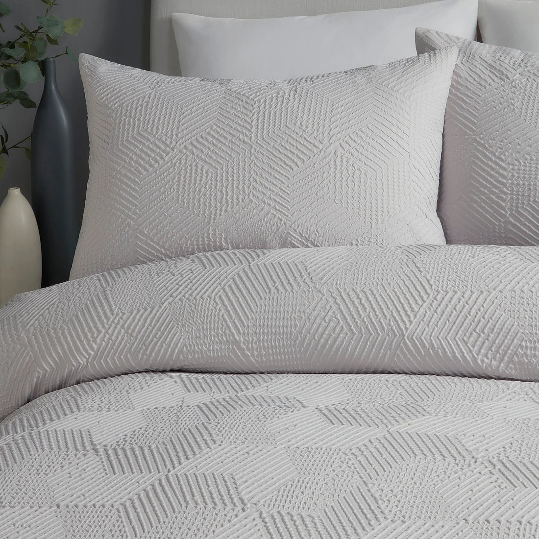 Close-up of the embossed geometric texture on the Serene Embossed Geo duvet cover set.