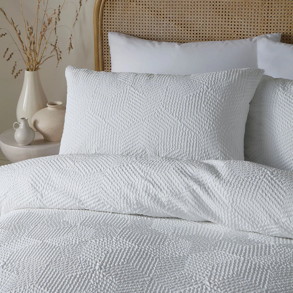 Close-up of the embossed geometric texture on the Serene Embossed Geo duvet cover set.