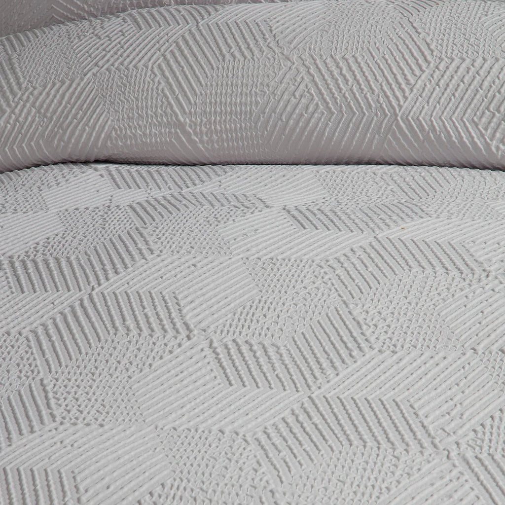 Close-up of the soft polyester fabric on the Serene Embossed Geo duvet cover set.