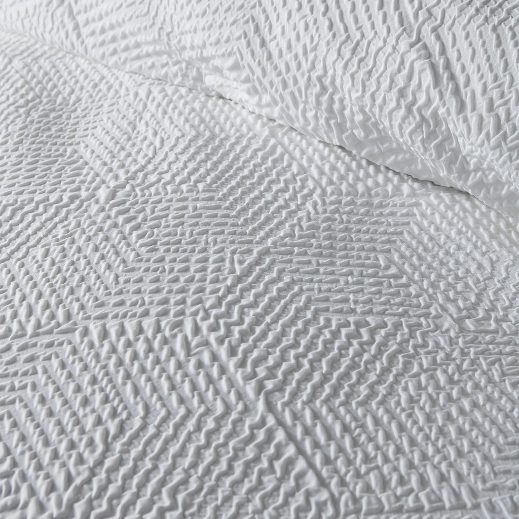 Close-up of the soft polyester fabric on the Serene Embossed Geo duvet cover set.