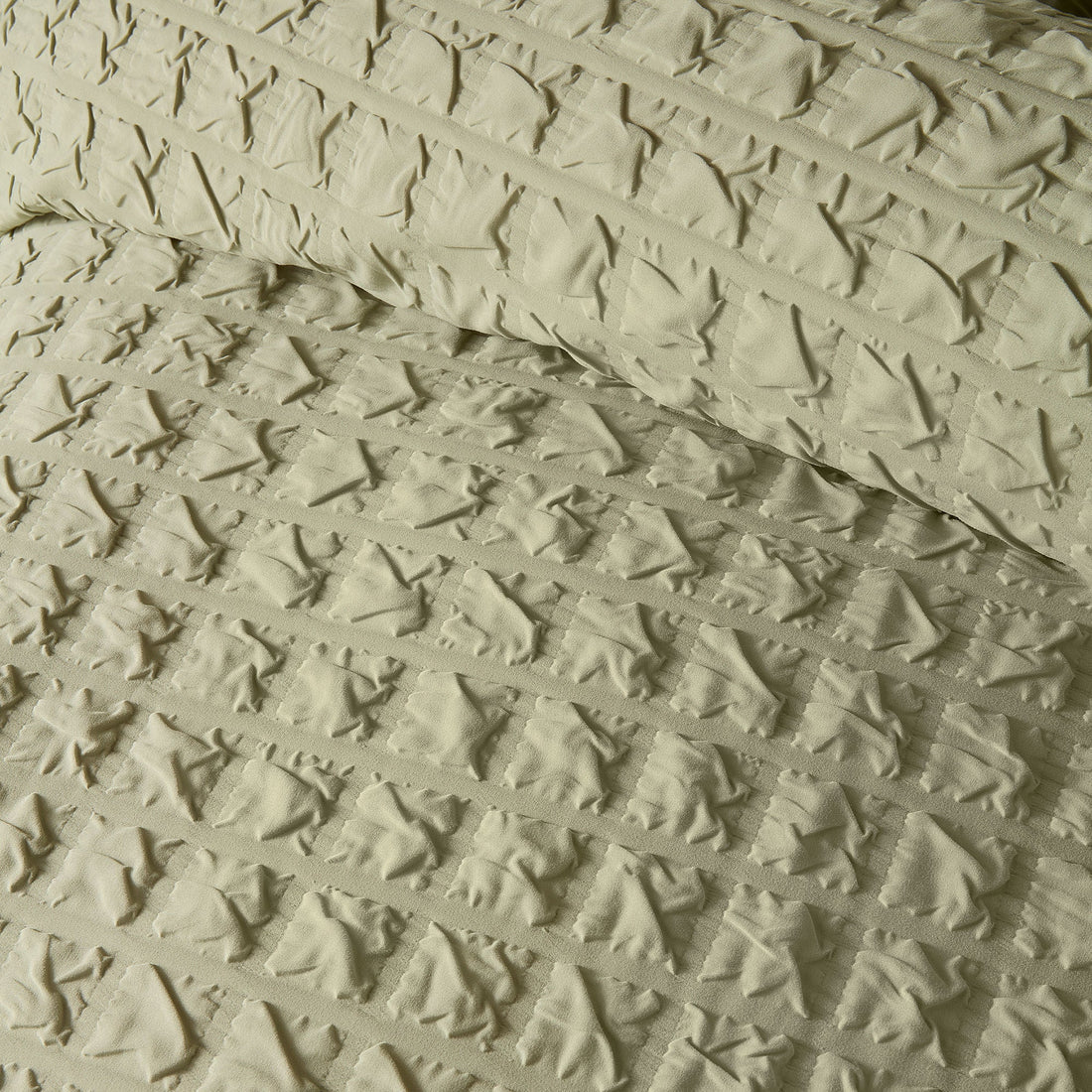 Close-up of the soft polyester fabric on the Serene Embossed Grid duvet cover set.