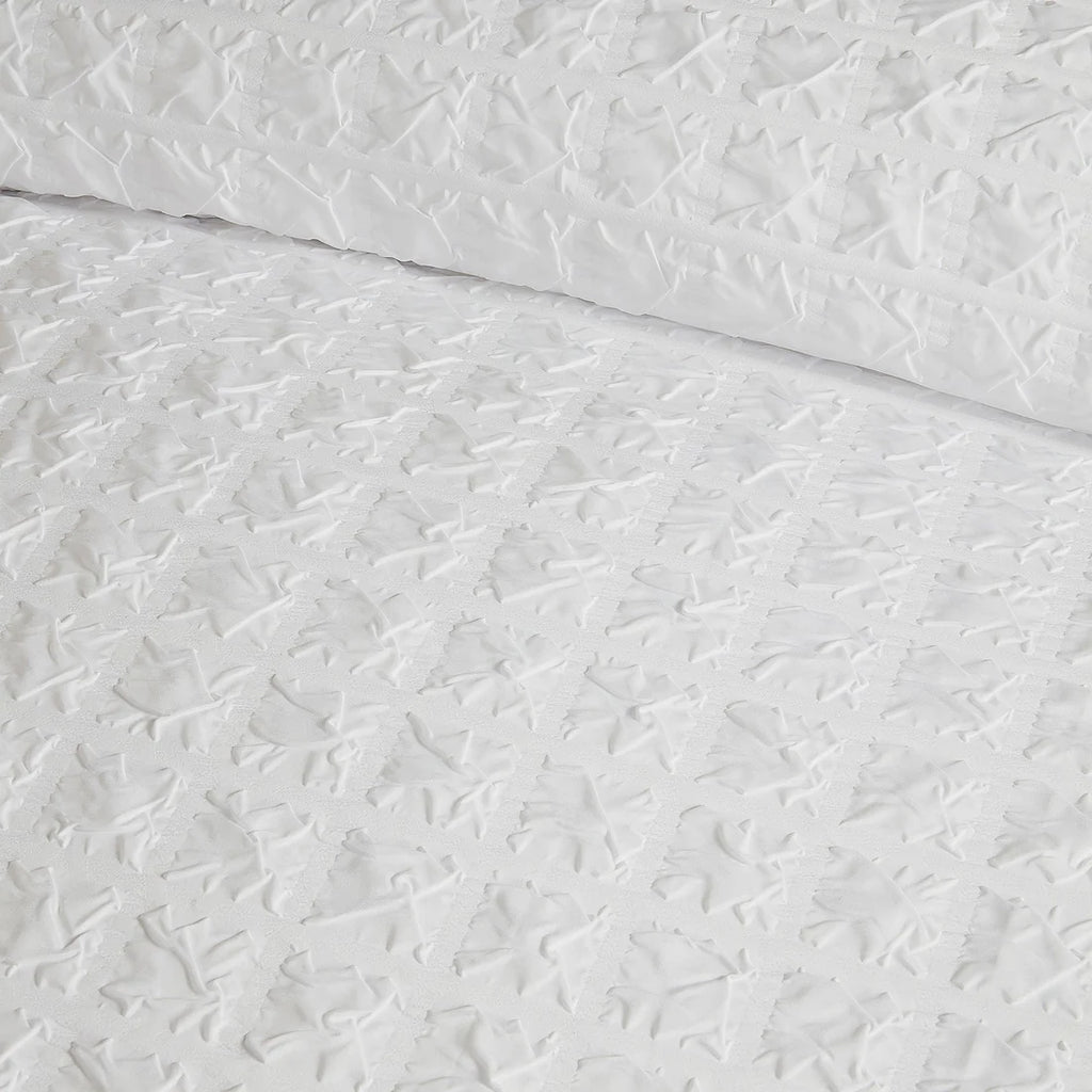 Close-up of the soft polyester fabric on the Serene Embossed Grid duvet cover set.
