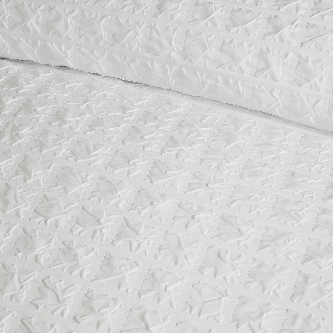 Close-up of the soft polyester fabric on the Serene Embossed Grid duvet cover set.