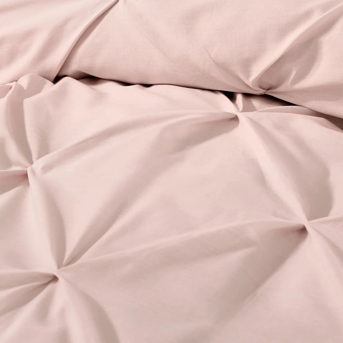 Close-up of the ruched textured design on the Serene Lara blush duvet cover set.