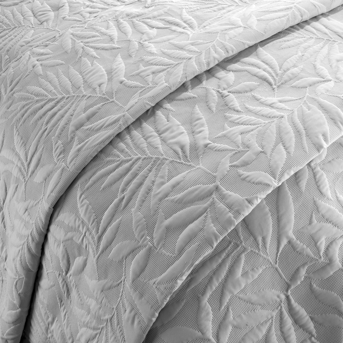 Close-up of the raised floral Pinsonic pattern on the Serene Luana bedspread.