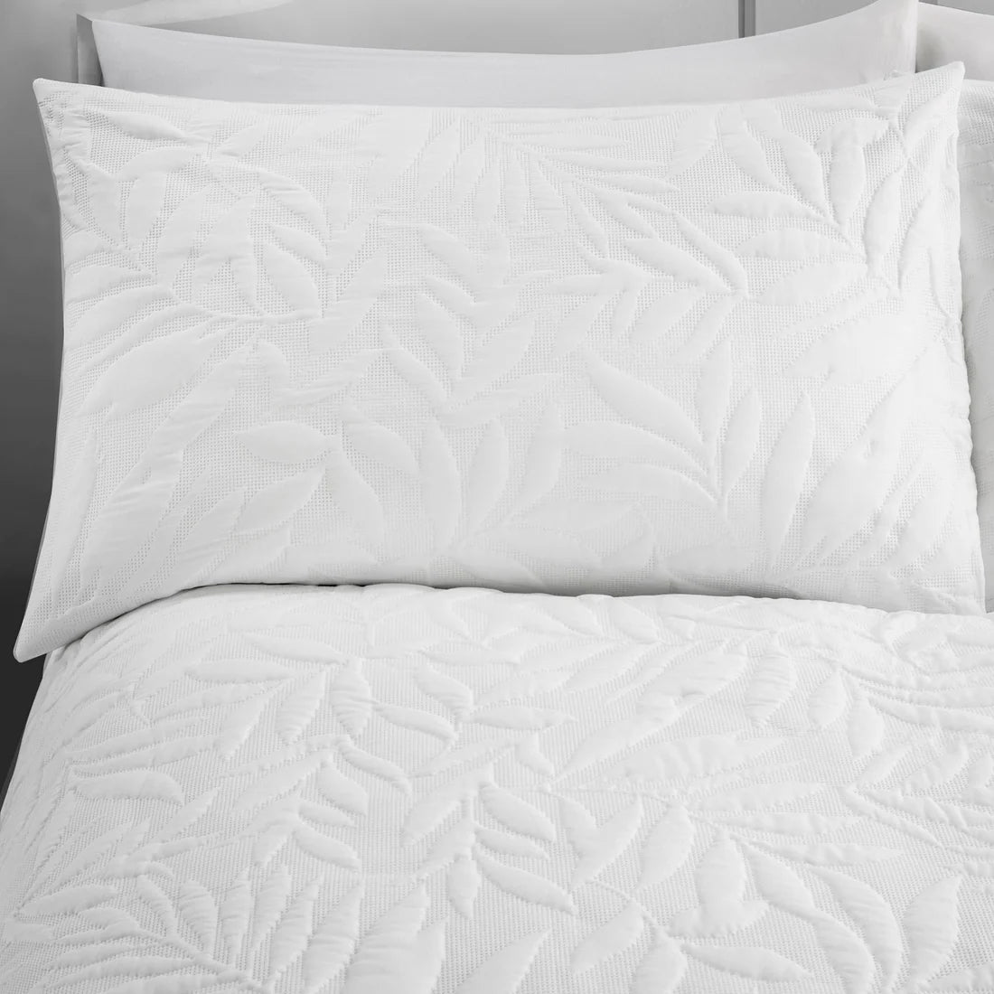 Close-up of the raised floral Pinsonic pattern on the Serene Luana white duvet cover set.