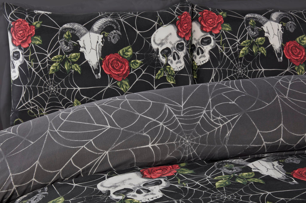 Close-up of the skull, crimson rose and spider web design on the Skulls & Roses duvet cover set.