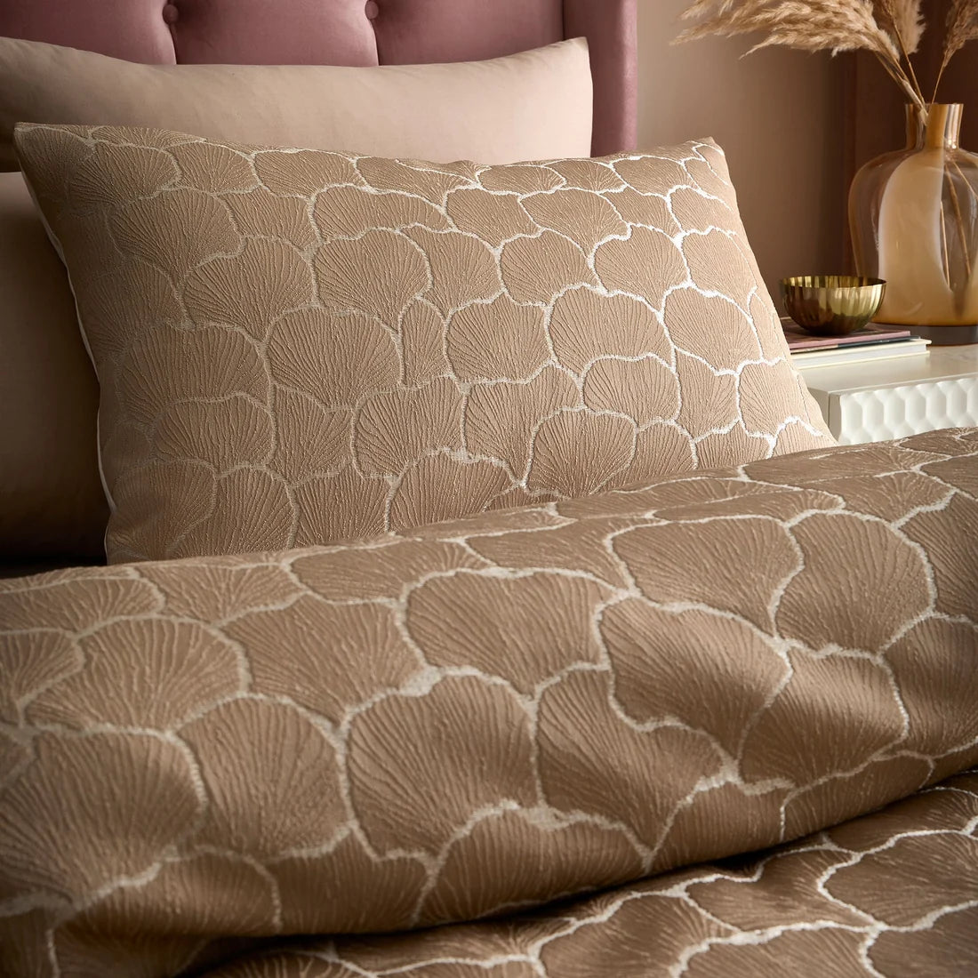 Close-up of the woven ginkgo leaf jacquard pattern with subtle shimmering detailing on the Soiree duvet cover set.