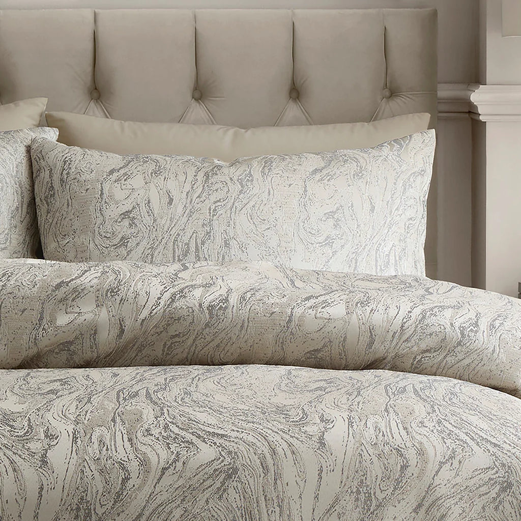 Close-up of the woven marble jacquard pattern with lustrous detailing on the Soiree duvet cover set.