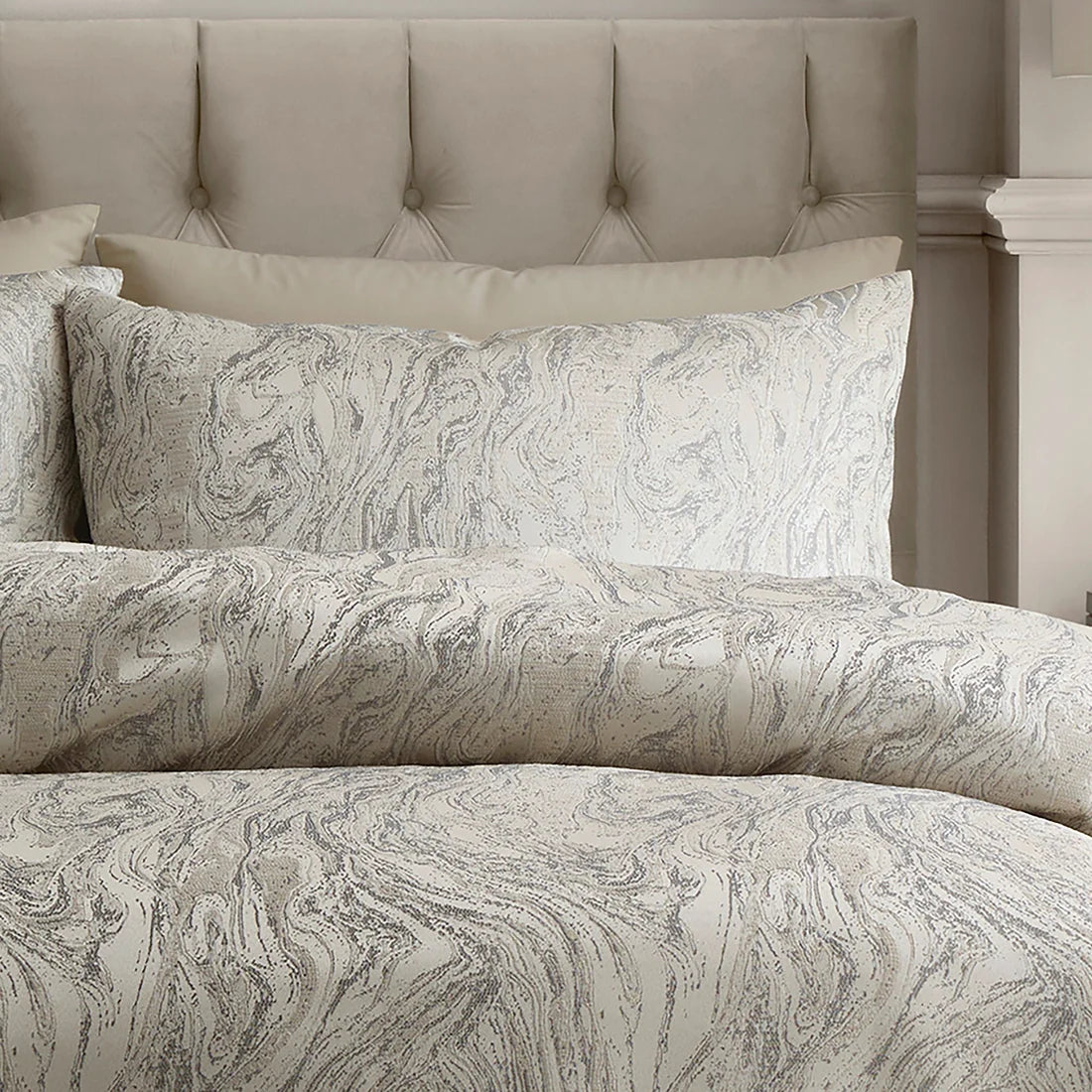 Close-up of the woven marble jacquard pattern with lustrous detailing on the Soiree duvet cover set.
