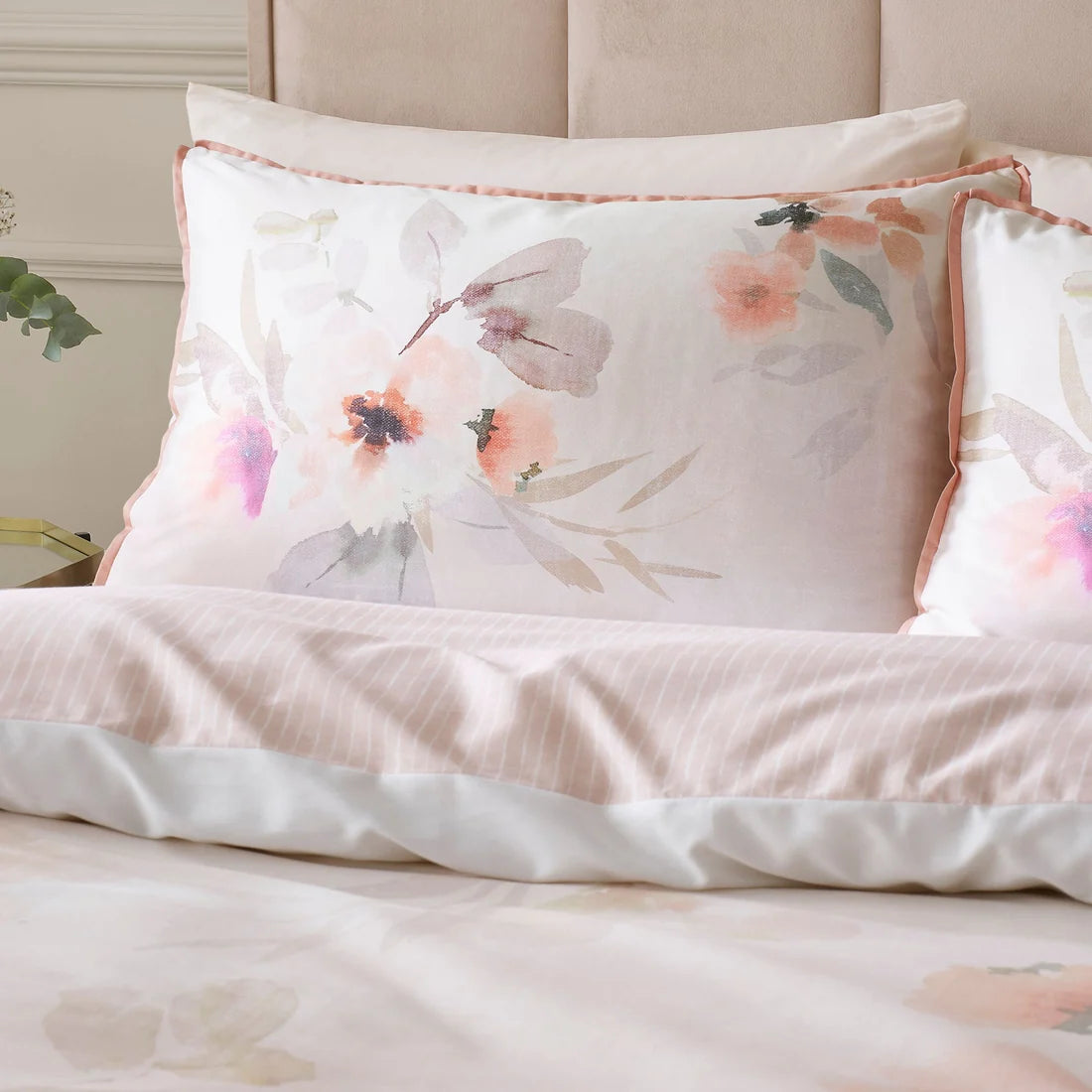 Close-up of the watercolour floral design and flat piped edging on the Soiree Mia Floral Blooms duvet cover set.