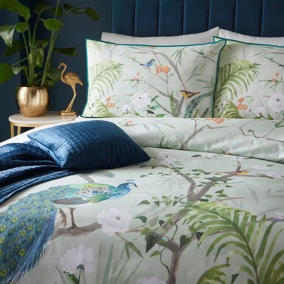 Close-up of the digitally printed peacock and tropical foliage design on the Soiree Peacock Jungle duvet cover set.