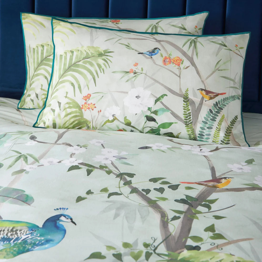 Close-up of the digitally printed peacock and tropical foliage design on the Soiree Peacock Jungle duvet cover set.