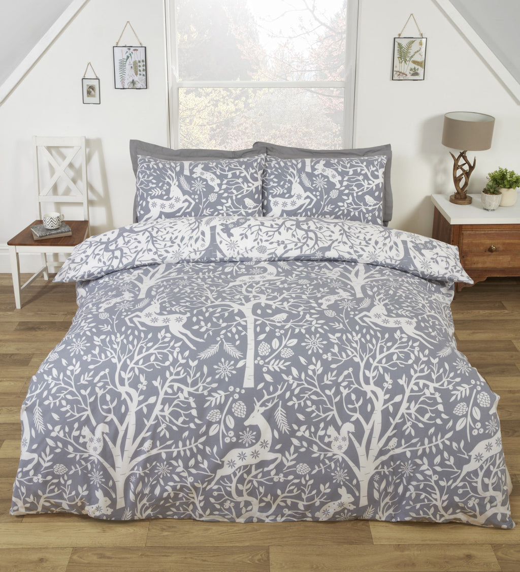 Tatton grey woodland duvet cover set styled in a cosy Scandinavian bedroom.