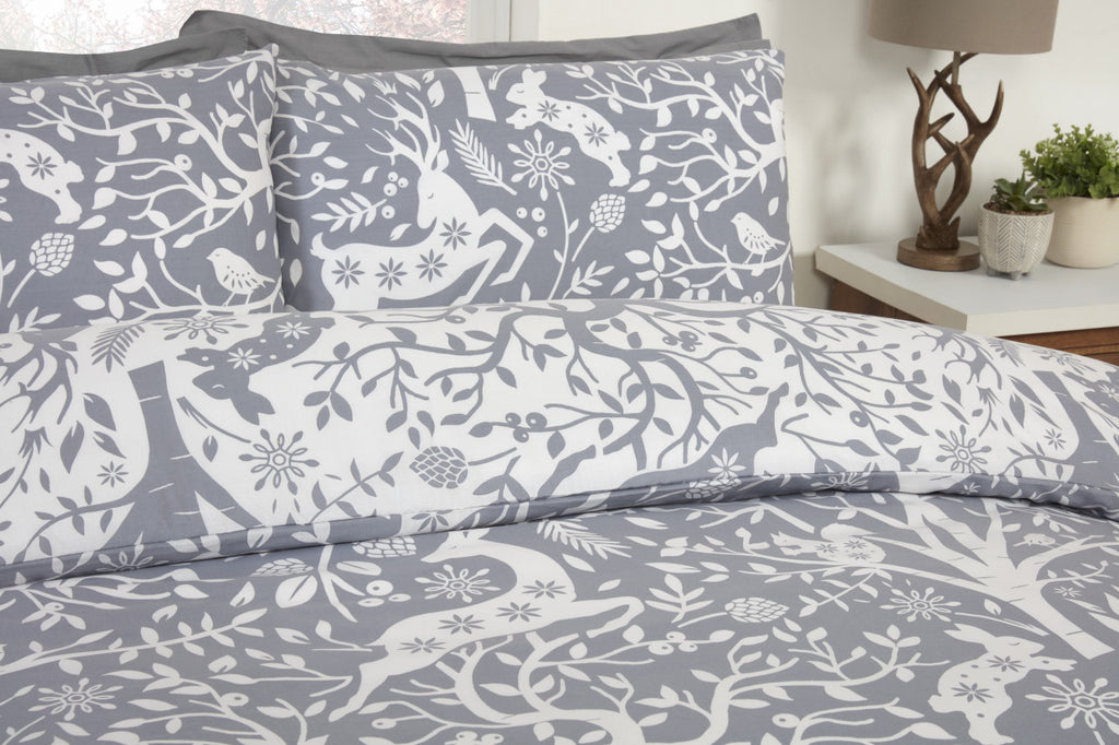 Close-up of the stag, rabbit and squirrel woodland design on the Tatton grey duvet cover set.