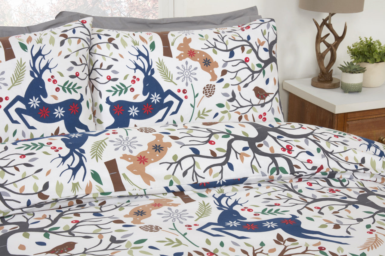 Close-up of the stag, rabbit and squirrel woodland design on the Tatton multi duvet cover set.