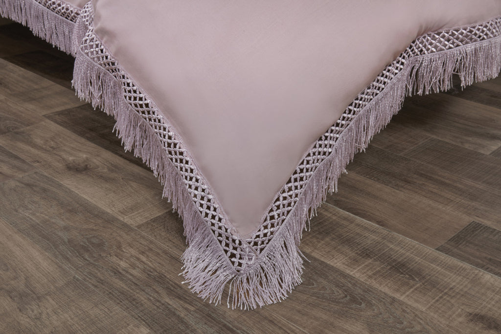 Close-up of the lace fringe trim on the Tia Trellis blush duvet cover set.
